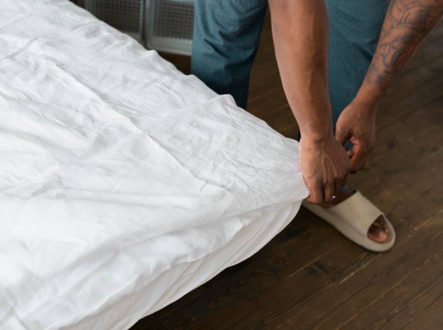 close-up-hands-making-bed